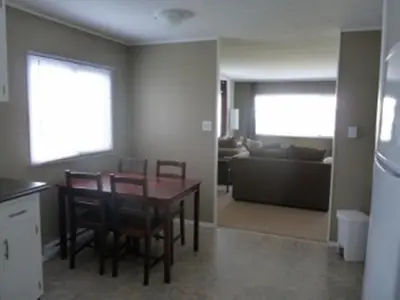 a kitchen and dining room with a table and chairs at Driftwood by the Sea Inn in Campbell River