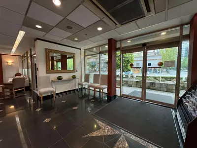 a lobby with a waiting room with chairs and a mirror at SureStay by Best Western Richmond Vancouver Airport in Richmond