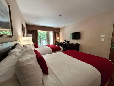 a hotel room with two beds and a television at SureStay by Best Western Richmond Vancouver Airport in Richmond