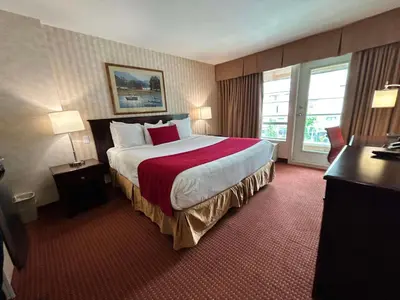 a hotel room with a large bed and a window at SureStay by Best Western Richmond Vancouver Airport in Richmond