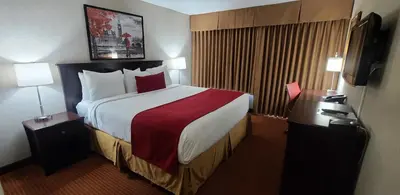 a hotel room with a large bed and two lamps at SureStay by Best Western Richmond Vancouver Airport in Richmond