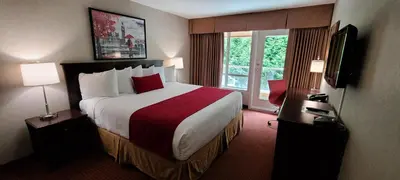 a hotel room with a large bed and a window at SureStay by Best Western Richmond Vancouver Airport in Richmond