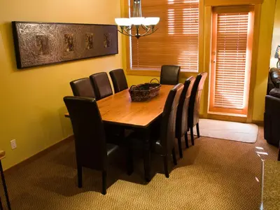 a dining room with a wooden table and chairs at Pinnacle Ridge Chalets by Fernie Lodging Co in Fernie