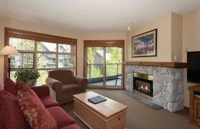 a living room with a couch and a fireplace at The Aspens by Whistler Premier in Whistler