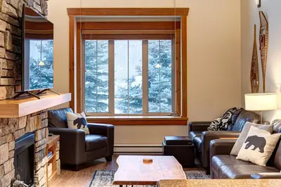 a living room with couches and a fireplace at Pinnacle Ridge Condos by Fernie Central Reservations in Fernie