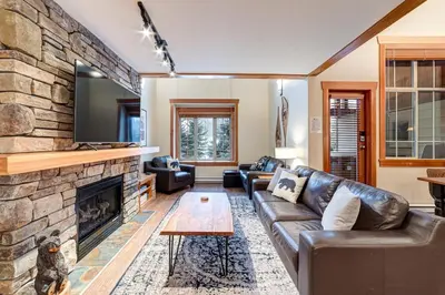 a living room with a couch and a fireplace at Pinnacle Ridge Condos by Fernie Central Reservations in Fernie