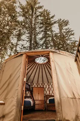 an open door of a tent with a bed in it at Riverside Resort in Whistler
