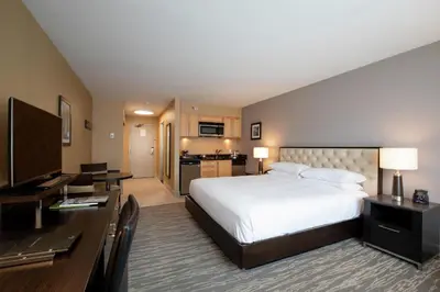 a hotel room with a large bed and a desk at Hilton Whistler Resort & Spa in Whistler