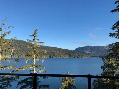 a view of a lake from a fence at Port Renfrew Vacation Rentals in Port Renfrew