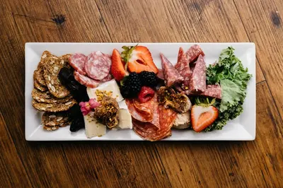 a white plate of food on a wooden table at Summerland Waterfront Resort & Spa in Summerland