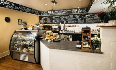 a coffee shop with a counter with a refrigerator at Summerland Waterfront Resort & Spa in Summerland