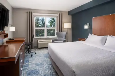 a hotel room with a bed and a desk and a window at Four Points by Sheraton Victoria Gateway in Victoria