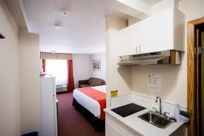 a hotel room with a bed and a sink at Super 8 by Wyndham Drayton Valley in Drayton Valley