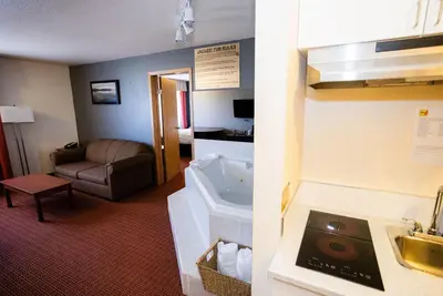 a hotel room with a sink and a bathroom at Super 8 by Wyndham Drayton Valley in Drayton Valley