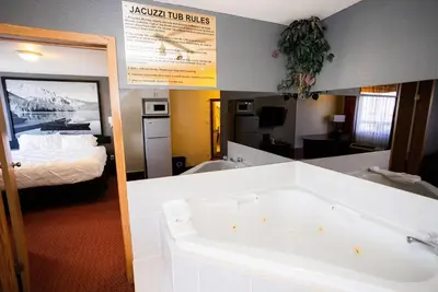a bathroom with a bath tub in a hotel room at Super 8 by Wyndham Drayton Valley in Drayton Valley