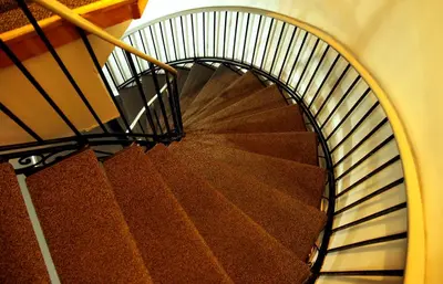 a spiral staircase in a building with brown stairs at Hotel Squamish in Squamish