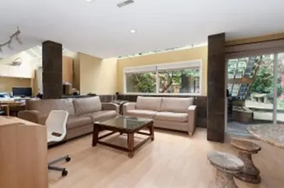a living room with a couch and a table at House On Dunbar B&B in Vancouver