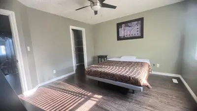a bedroom with a bed and a ceiling fan at Monthly Accommodation Edmonton Londondery, Pilot Sound, McConachie Area in Edmonton
