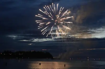 a firework display in the sky over the water at Skylite Motel in Parksville