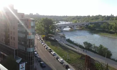a bridge over a river with a bunch of cars at ELEMENT ON FIRST by Manna in Calgary
