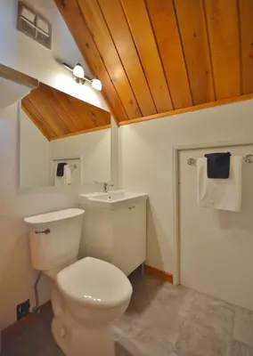 a bathroom with a white toilet and a sink at Pender Harbour Resort & Marina in Garden Bay