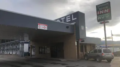 a car parked in front of a gas station at Houston Motor Inn in Houston