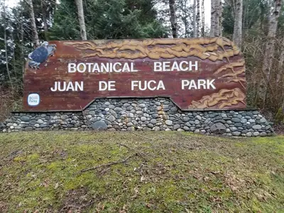 a sign at the entrance to a park at Newfie Seaside Retreat in Port Renfrew