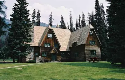 a large wooden house in the middle of a field at Manning Park Resort in Manning Park