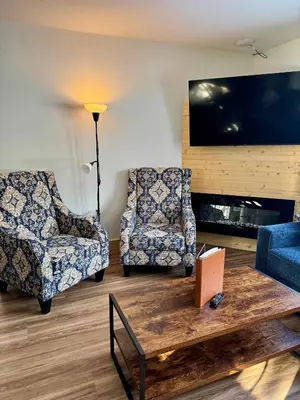 a living room with two chairs and a coffee table at Manning Park Resort in Manning Park