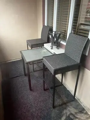 a room with two chairs and a table and a window at Town Plaza Suites by Golden Dreams in Whistler