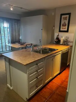 a kitchen with a sink and a counter top at Town Plaza Suites by Golden Dreams in Whistler