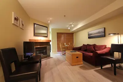 a living room with a couch and a fireplace at Marketplace Lodge by Whistler Retreats in Whistler
