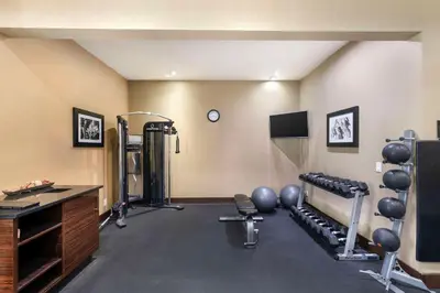 a fitness room with a gym with weights at Best Western Pacific Inn in Vernon
