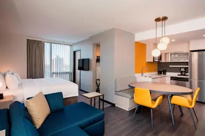 a hotel room with a king bed and a kitchen at Residence Inn by Marriott Calgary Downtown/Beltline District in Calgary
