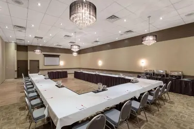 a conference room with a long table and chairs at Ramada by Wyndham Northern Grand Hotel & Conference Centre in Fort Saint John