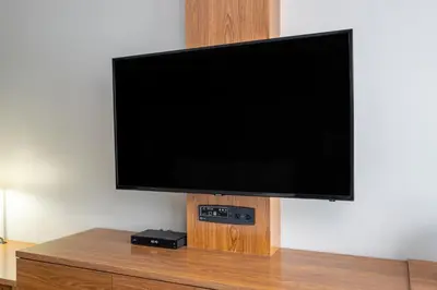 a flat screen tv hanging on a wall at Ramada by Wyndham Northern Grand Hotel & Conference Centre in Fort Saint John