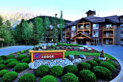 a sign in a garden in front of a lodge at Pemberton Valley Lodge in Pemberton
