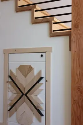 a stairwell with a glass shelf and wooden railings at Le Chalet Waterfront Retreat in Ucluelet