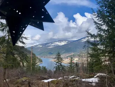 a view of a body of water with mountains at Morning Star Cabin in Nelson