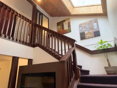a staircase in a house with a skylight at Sunshine Lodge Inn in Gibsons