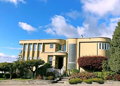 a large house with a cross on top of it at Star of the Sea guest house in White Rock