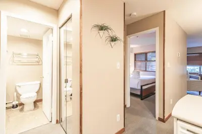 a bathroom with a toilet and a bedroom at Lake Placid Lodge by Elevate Vacations in Whistler