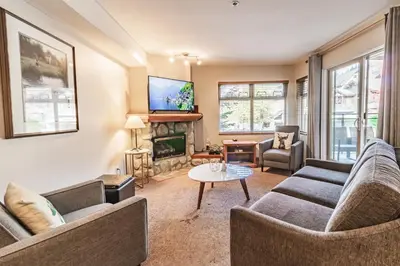 a living room with two couches and a fireplace at Lake Placid Lodge by Elevate Vacations in Whistler