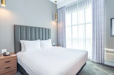 a bedroom with a large bed and a large window at Sandman Signature Sherwood Park Hotel in Sherwood Park