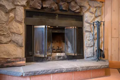 a stone fireplace in a stone wall at The Hidden Ridge Resort in Banff
