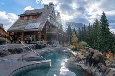 a house with a swimming pool in front of it at The Hidden Ridge Resort in Banff