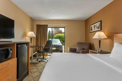 a hotel room with a bed and a desk and a television at Comfort Inn West in Edmonton