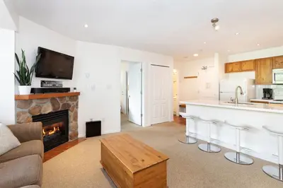 a living room with a couch and a fireplace at Bear Lodge (Town Plaza) in Whistler