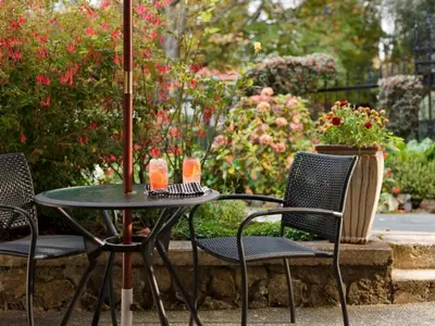 a patio table with two chairs and an umbrella at Abbeymoore Manor in Victoria