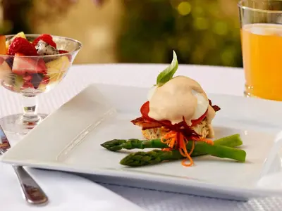 a white plate with a dessert and a glass of orange juice at Abbeymoore Manor in Victoria